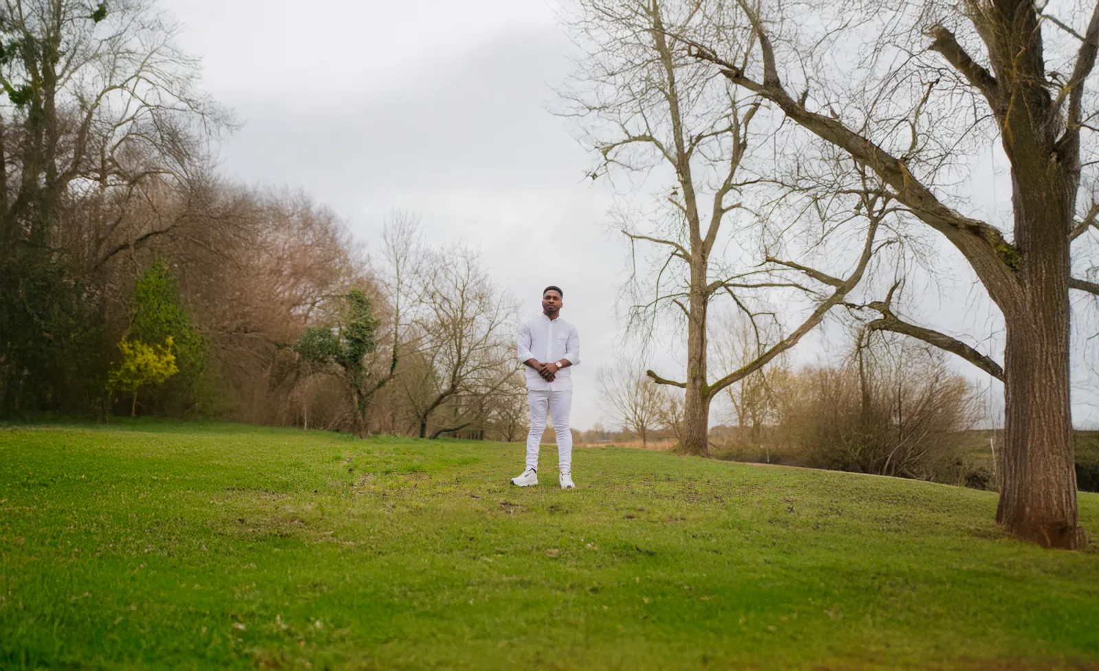 John Great in a wide, quiet park landscape